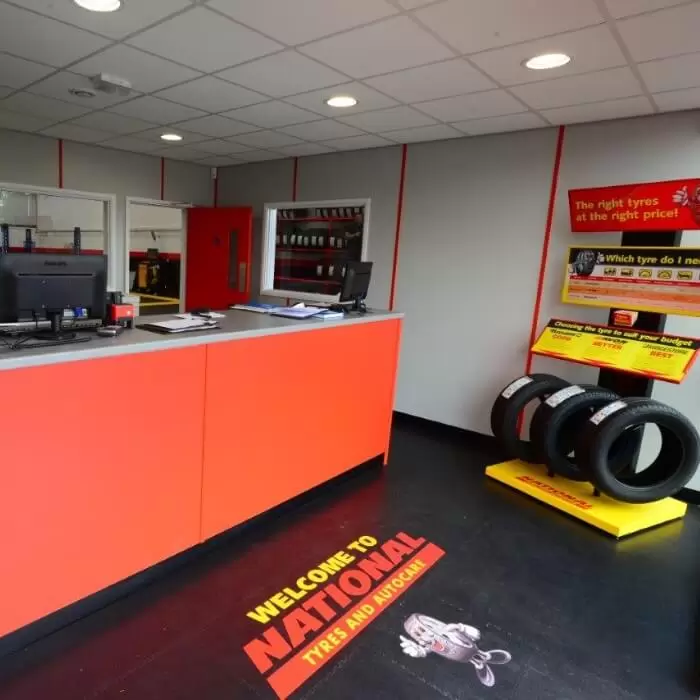National Tyres reception area with interlocking garage floor tiles featuring a printed brand logo