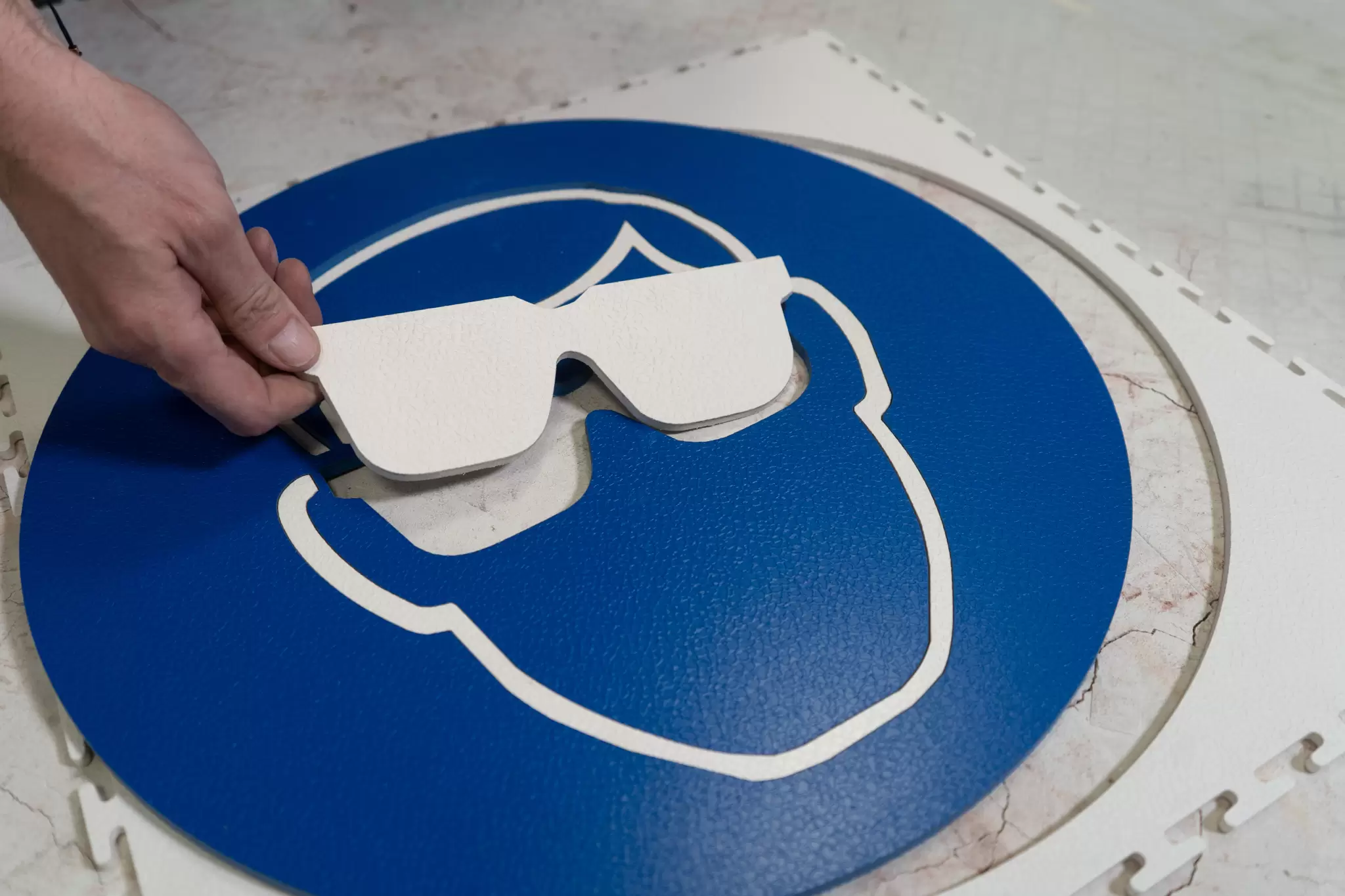 Ecotile floor signs are created from original Ecotiles, using water jet cutting to create the logo or sign design