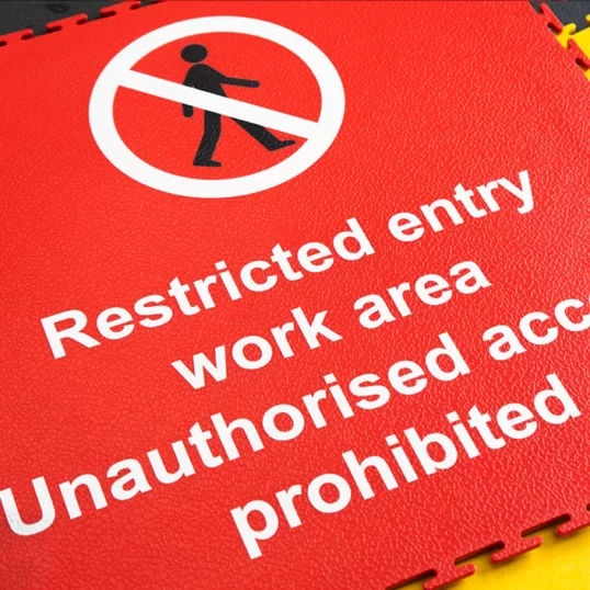 Floor graphic showing restricted entry work area official safety sign