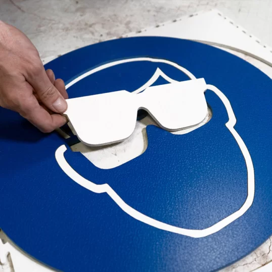 Image showing how Ecotile waterjet cut tiles can create HSE mandatory safety signage like eye wear protection