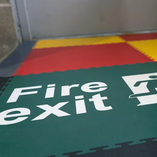 Photo of fire exit floor signage printed directly on to an Ecotile floor