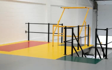 A new mezzanine floor with Ecotile floor tiles creating a durable floor covering, with multi-coloured tiles marking out stair entrances and goods in bays