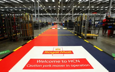 Royal Mail warehouse with ecotile applied to walkways, combining coloured tiles with brand logo and caution messaging for fork lift trucks operating