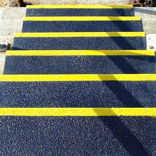 suregrip stair tread covers on external steps leading down the stair case in black with yellow edges to each step