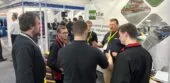 Visitors to the Ecotile exhibition stand discuss interlocking floor tiles during the Southern Manufacturing and Electronics show