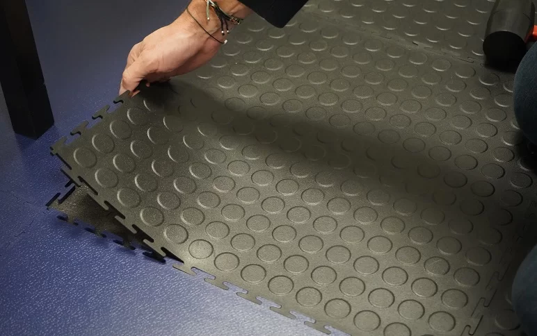 inserting an ecotile anti-fatigue floor tile into an ecotile industrial interlocking floor system