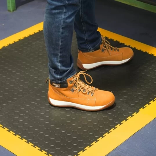Standalone mat created from Ecotile anti-fatigue, with yellow ramps around edges for safety