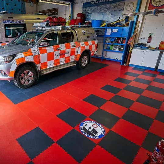 Small Buxtom Mountain Rescue logo floor sign printed on workshop floor