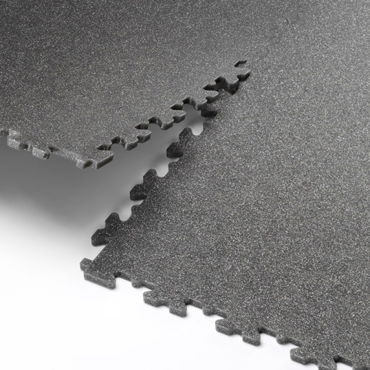 A close up image showing two Ecotile speckled tiles interlocking together