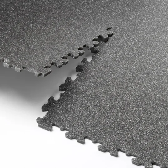 A close up image showing two Ecotile speckled tiles interlocking together