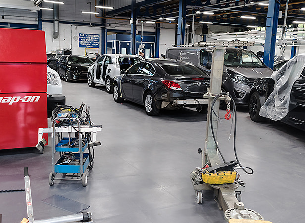 Multiple cars, tools, trolley jacks and more on Ecotile floor