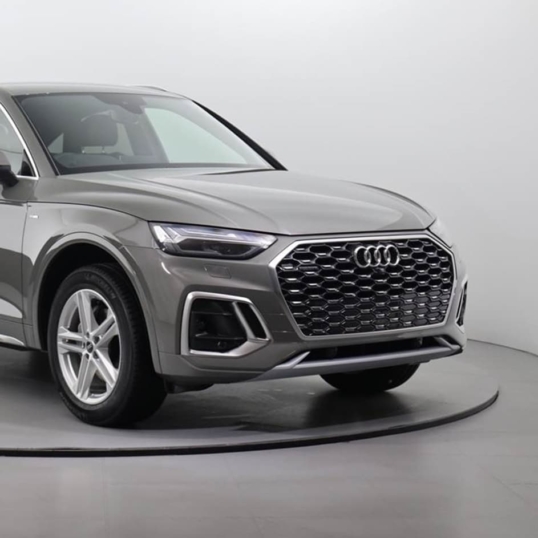 Vehicle showroom with light grey interlocking floor tiles