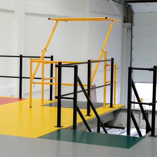 Image showing different colour Ecotile floor tiles being used to designate different areas of the mezzanine warehouse pallet gate