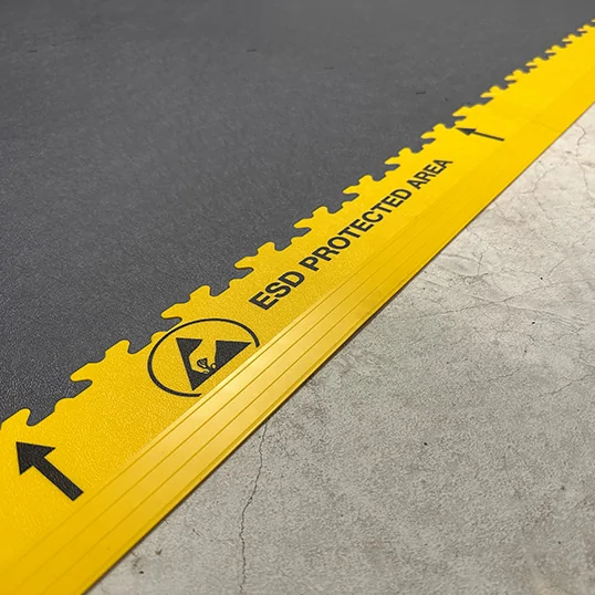 Close up of ecotile esd floor on a cocnrete floor showing printed edge ramps to idenify esd area