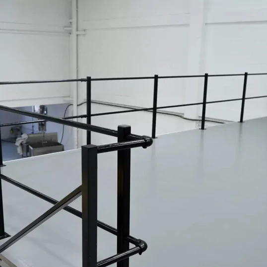 Ecotile mezzanine floor covering around railing